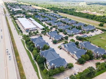 A suburban neighborhood with houses and a road.